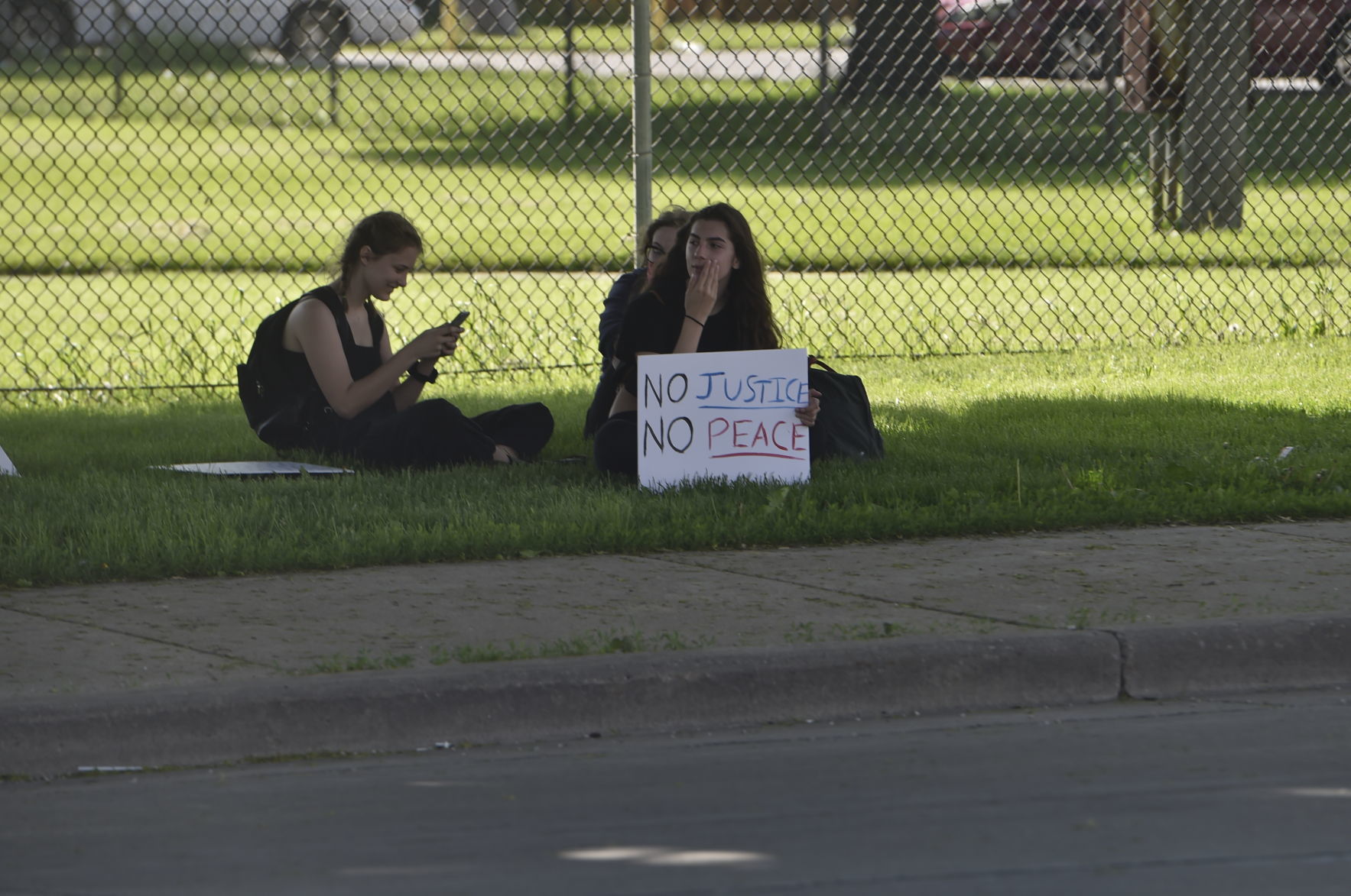 No Justice No Peace sign while taking a break in the shade